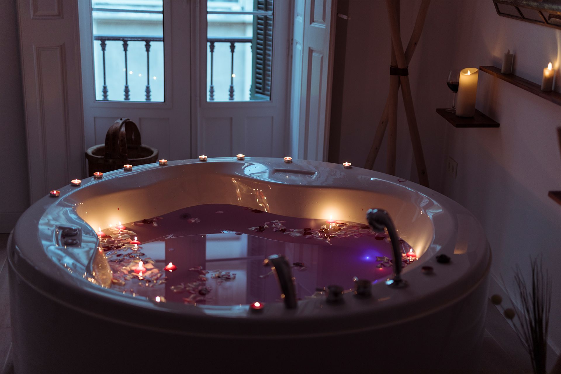 A luxurious bathtub with rose petals